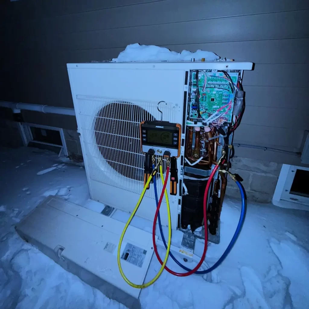 Air conditioning unit covered in snow
