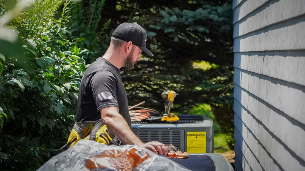 Technician working on air conditioning unit
