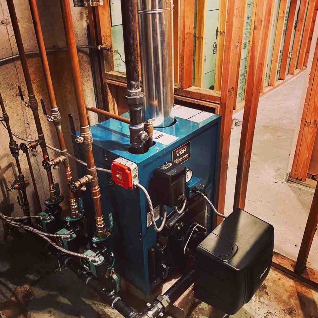 HVAC technician inspecting furnace in Rhode Island home